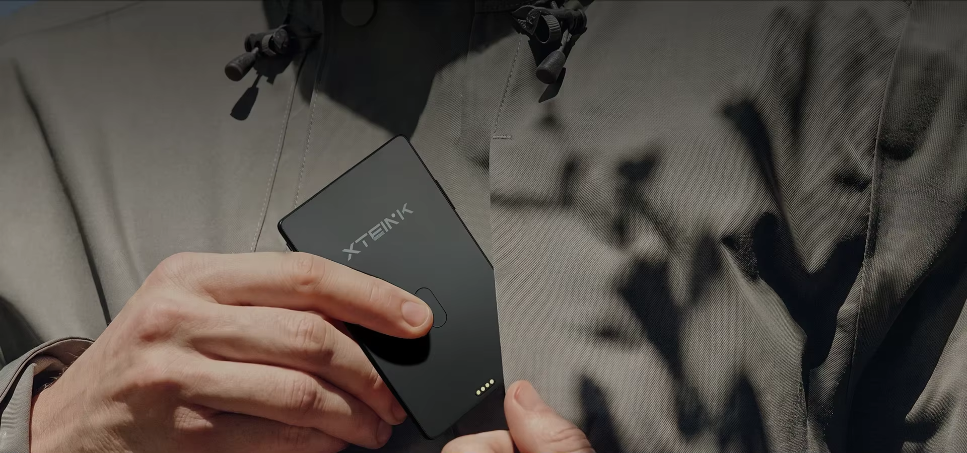 XTEINK X4 Classic black e-reader carried close to a jacket